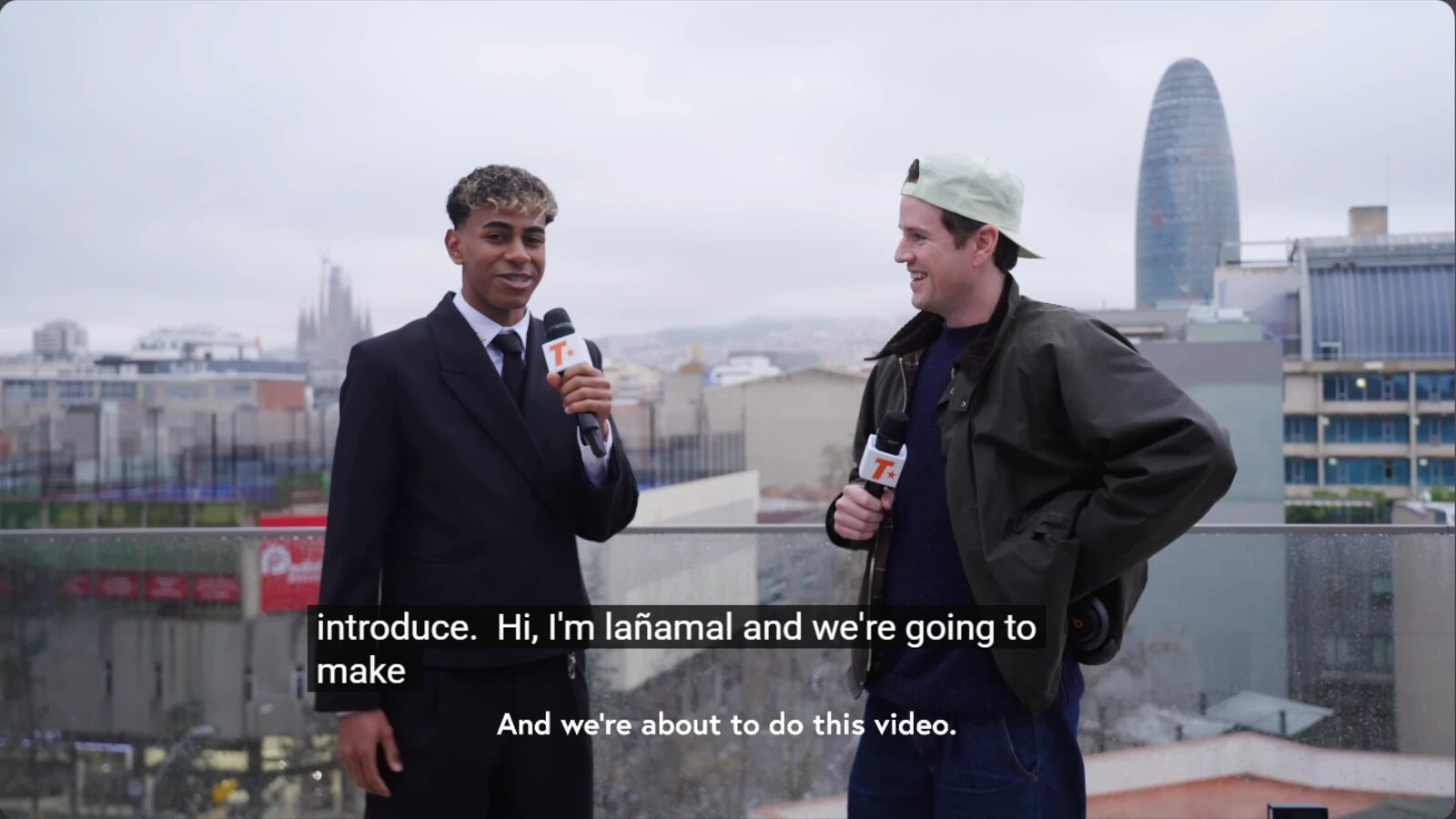 Lamine Yamal and Track Star host Jack Coyne stand outdoors holding microphones, with subtitles across the lower part of the frame.
