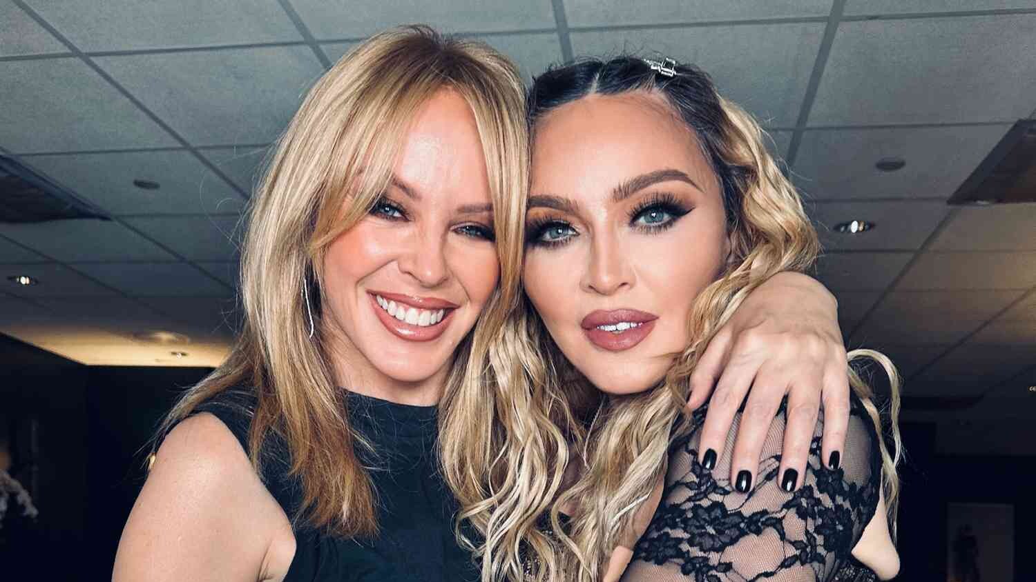 Kylie Minogue and Madonna embrace and smile for the camera in a close-up portrait.
