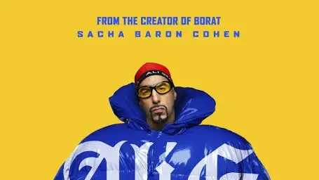 Promotional poster showing Sacha Baron Cohen as Ali G in yellow glasses, a red cap and an oversized blue puffer outfit against a bright yellow background, with the film title and release text overlaid.