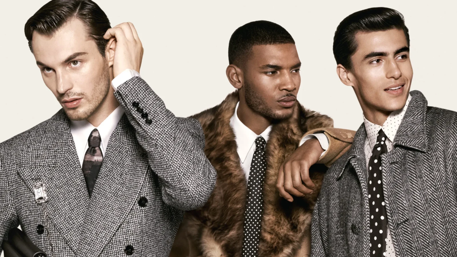 Three male models pose in tailored houndstooth and pinstriped outerwear, including a fur-trimmed coat, patterned shirts and ties.